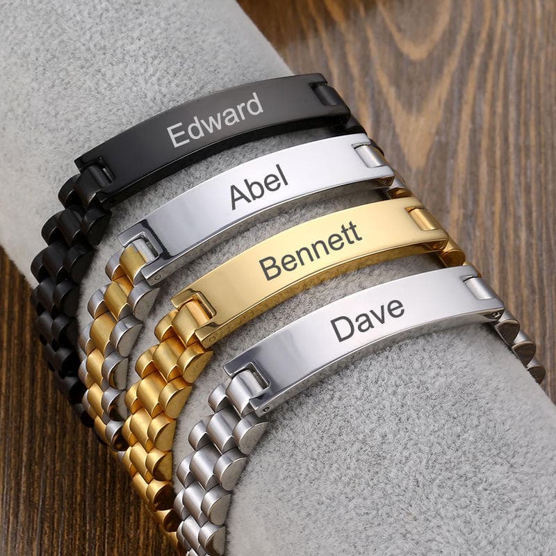 Custom name stainless steel watch-band bracelets in black, silver, gold and two-tone, each engraved with a name